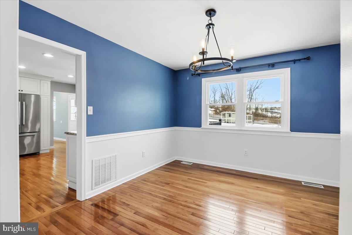 11 North Williamson Road Avondale, PA 19311 - Photo 5 of 36 a view of an empty room with wooden floor and a window