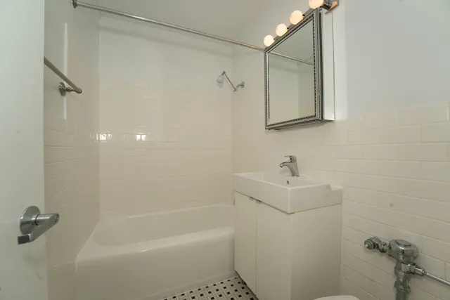 a bathroom with a shower a sink and a mirror