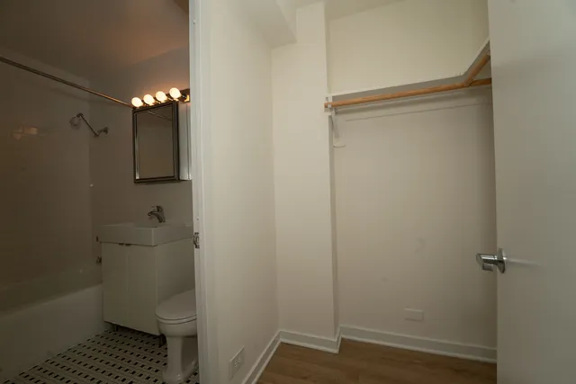 a bathroom with a granite countertop toilet and a shower