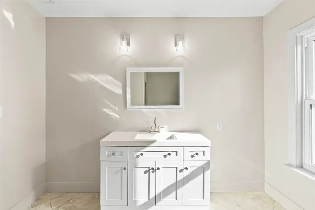 a bathroom with a sink a vanity and a mirror