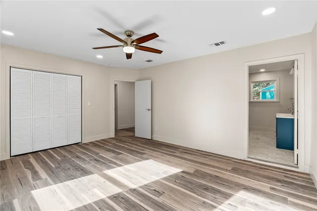 a view of a livingroom with a ceiling fan and wooden floor
