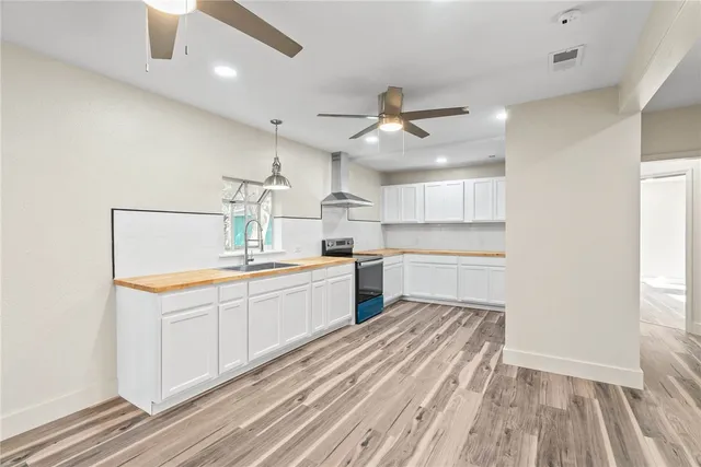 a kitchen with granite countertop a sink appliances cabinets and a counter top space