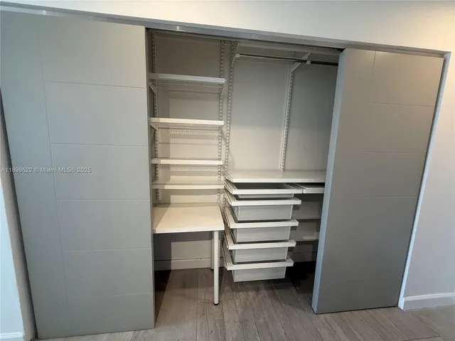 a view of a room with wooden floor