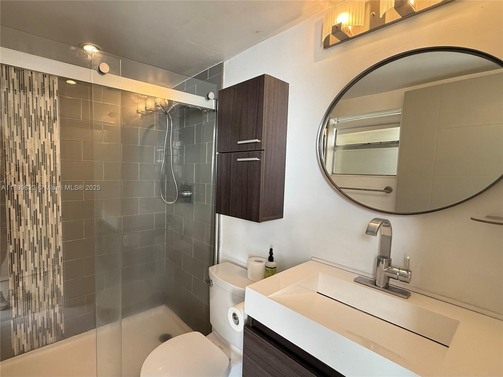 1441 Lincoln Road, Unit 317 Miami Beach, FL 33139 - Photo 6 of 31 a bathroom with a sink toilet and shower