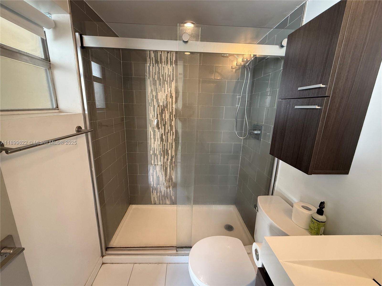 1441 Lincoln Road, Unit 317 Miami Beach, FL 33139 - Photo 7 of 31 a bathroom with a sink toilet and shower