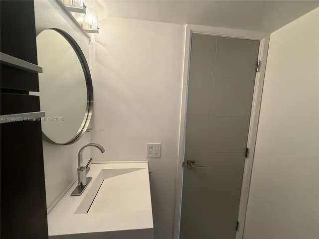 a bathroom with a shower and a mirror