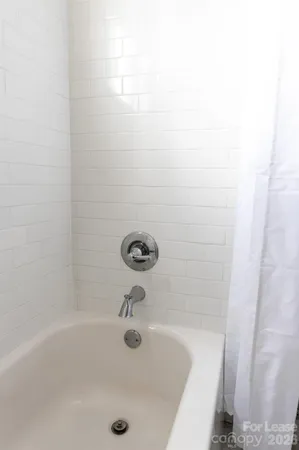 a bathroom with a granite countertop toilet sink and mirror