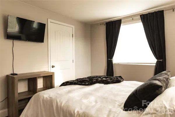 a bedroom with a bed and window