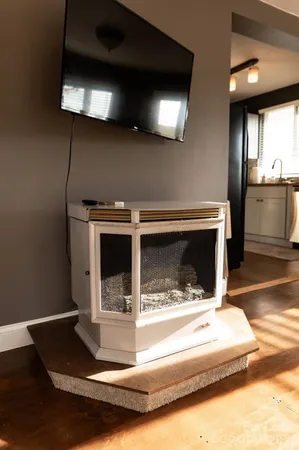 a bedroom with a bed window and dresser