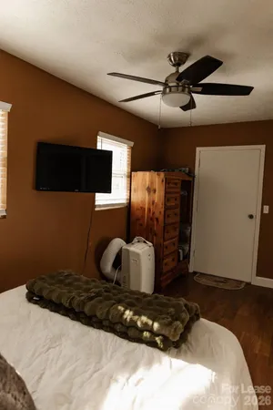 a bedroom with a bed and window
