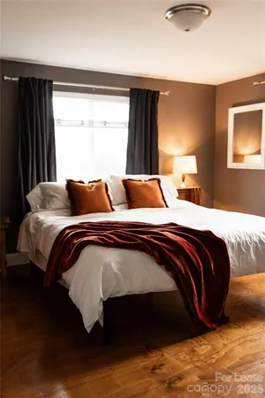 a bedroom with a bed and window