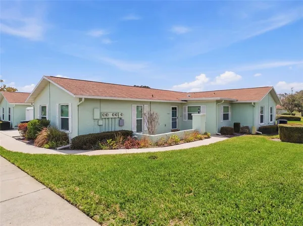 a view of a house with a yard and plants