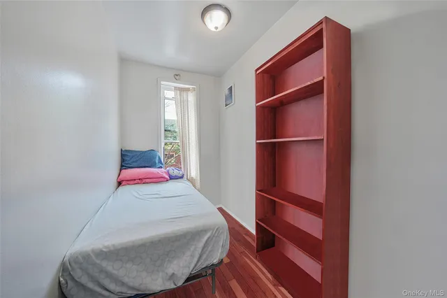 a room with a bed and a dresser