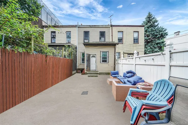 a backyard of a house with table and chairs