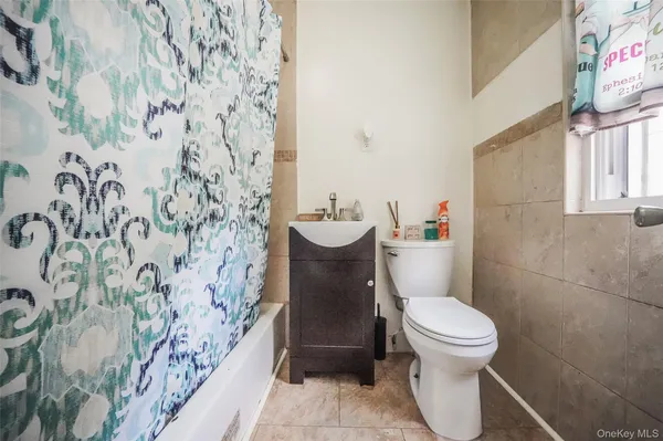 a white toilet sitting next to a bathroom sink