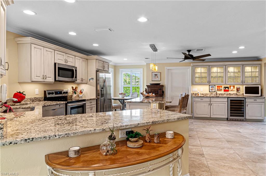 a kitchen with stainless steel appliances granite countertop a sink a stove and a microwave