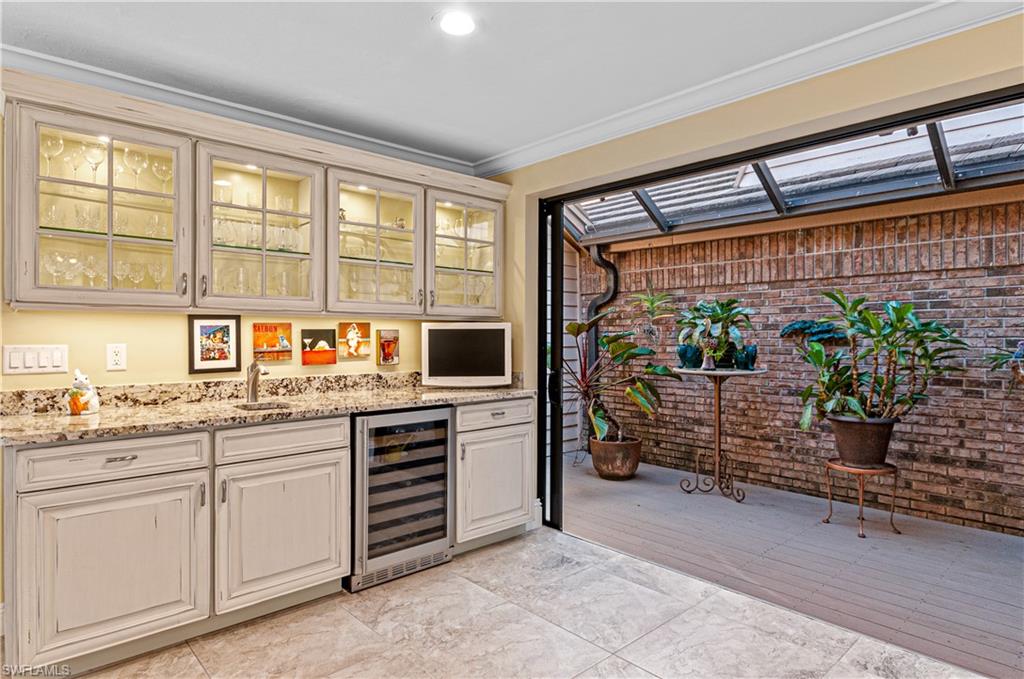 4022 Crayton Road Naples, FL 34103 - Photo 11 of 28 a open kitchen with stainless steel appliances granite countertop a stove and more cabinets