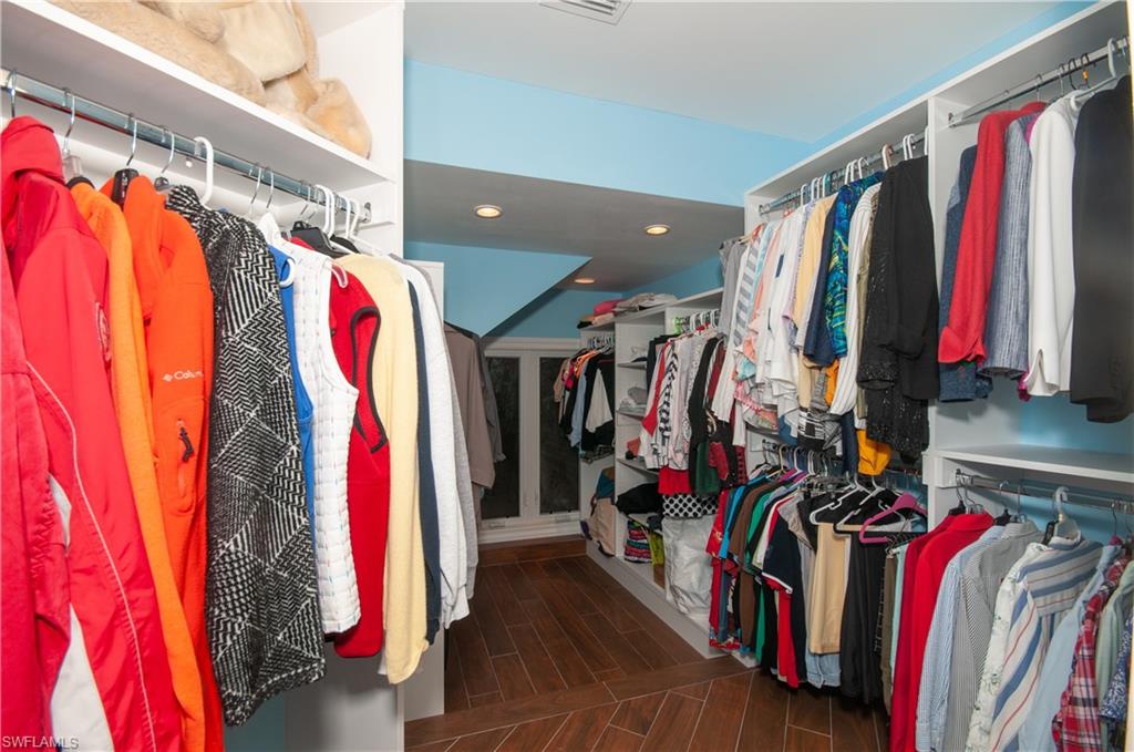 4022 Crayton Road Naples, FL 34103 - Photo 15 of 28 a view of walk in closet with clothes