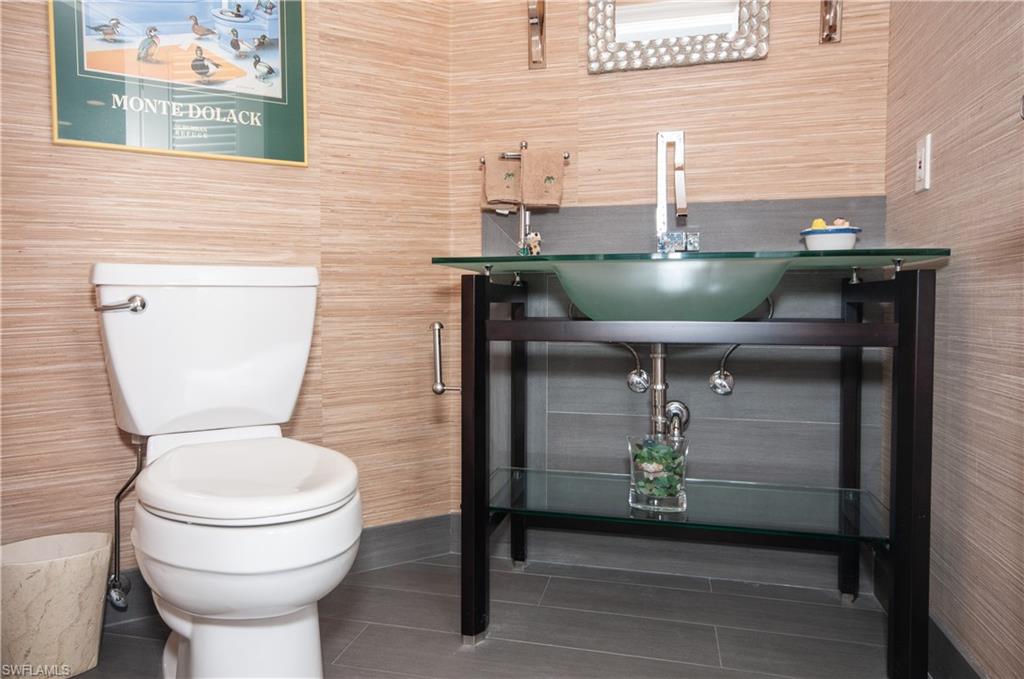 4022 Crayton Road Naples, FL 34103 - Photo 16 of 28 a bathroom with a toilet and a sink