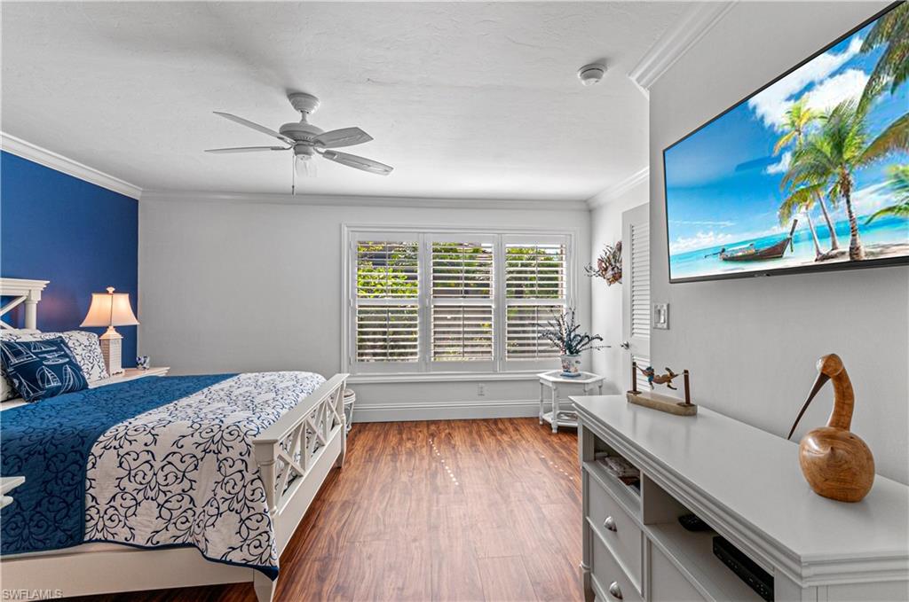 4022 Crayton Road Naples, FL 34103 - Photo 17 of 28 a bedroom with a bed and a large window