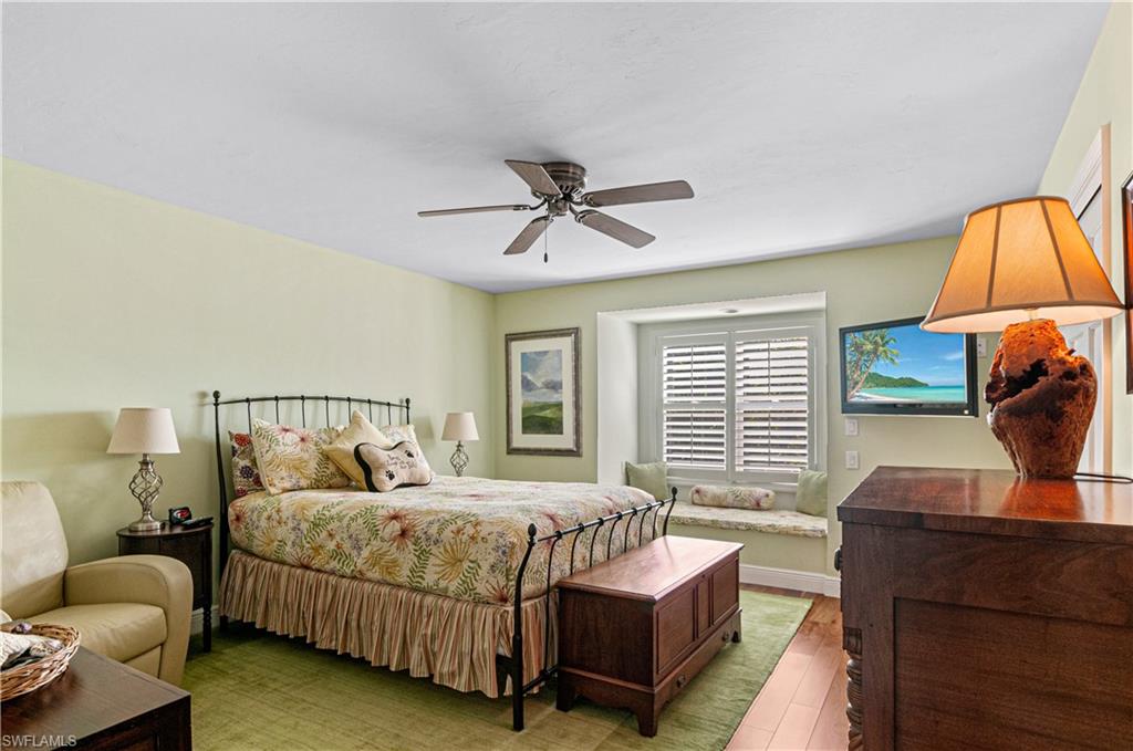 4022 Crayton Road Naples, FL 34103 - Photo 20 of 28 a bedroom with a bed and a couch