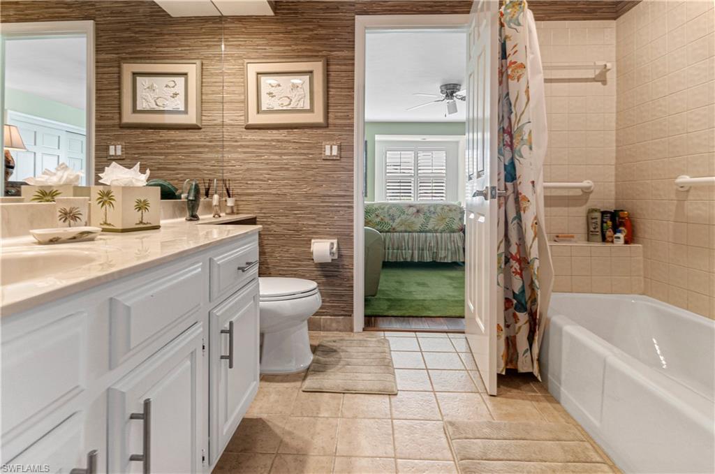 4022 Crayton Road Naples, FL 34103 - Photo 22 of 28 a bathroom with a sink a toilet and shower