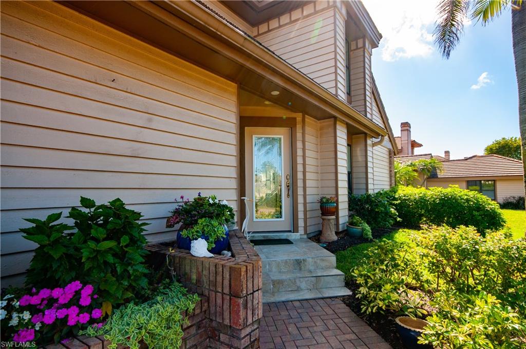 4022 Crayton Road Naples, FL 34103 - Photo 3 of 28 a view of a house with a backyard and sitting area