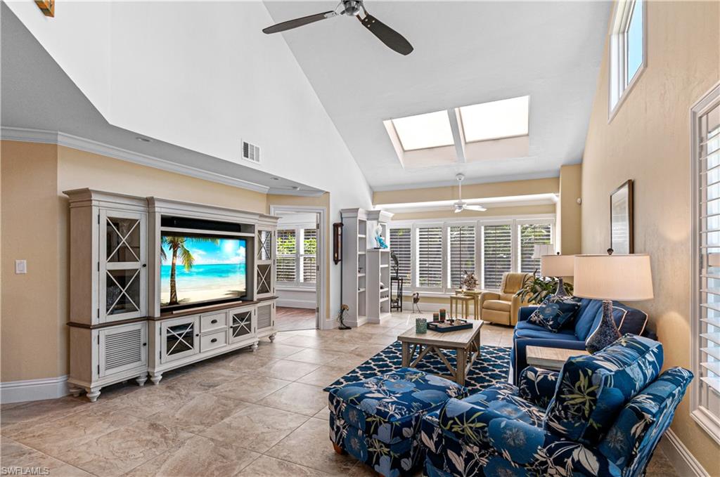 4022 Crayton Road Naples, FL 34103 - Photo 4 of 28 a living room with furniture and a flat screen tv