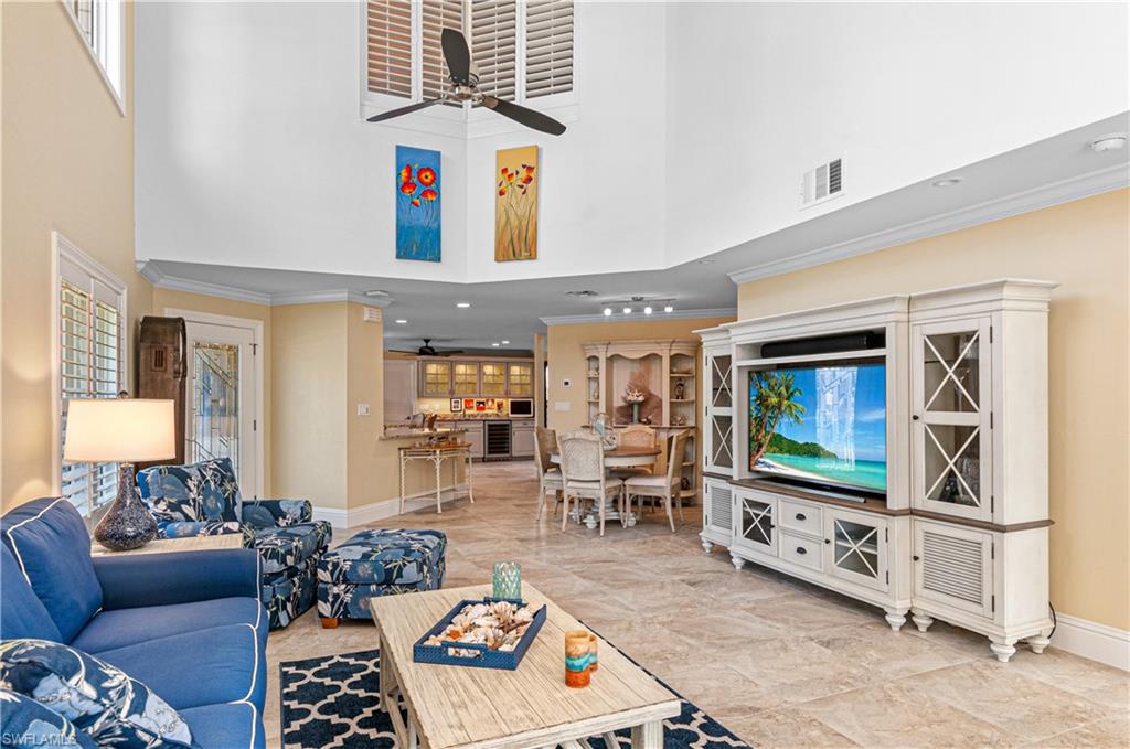 4022 Crayton Road Naples, FL 34103 - Photo 6 of 28 a living room with furniture and a flat screen tv
