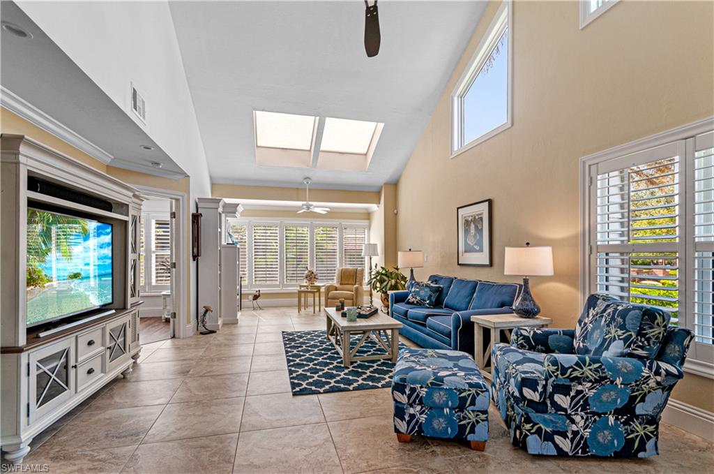 4022 Crayton Road Naples, FL 34103 - Photo 8 of 28 a living room with furniture large window and flat screen tv