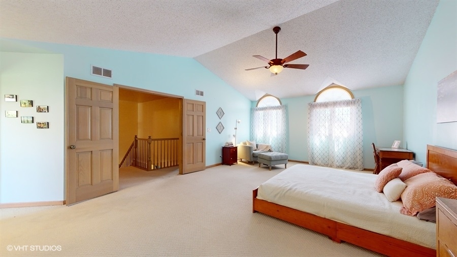 545 Abbey Road Bartlett, IL 60103 - Photo 15 of 28 a bedroom with bed mirror and window