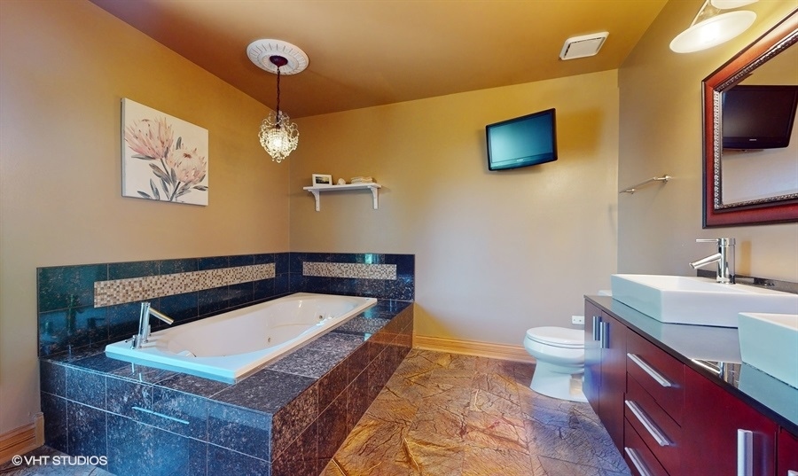 545 Abbey Road Bartlett, IL 60103 - Photo 17 of 28 a bathroom with a sink a toilet and mirror