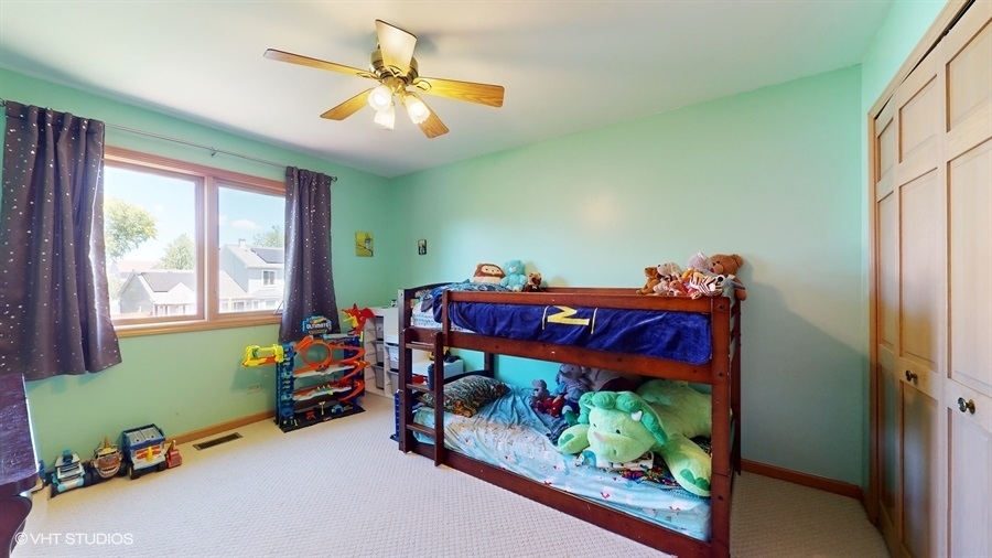 545 Abbey Road Bartlett, IL 60103 - Photo 19 of 28 a bedroom with two beds and a baby crib