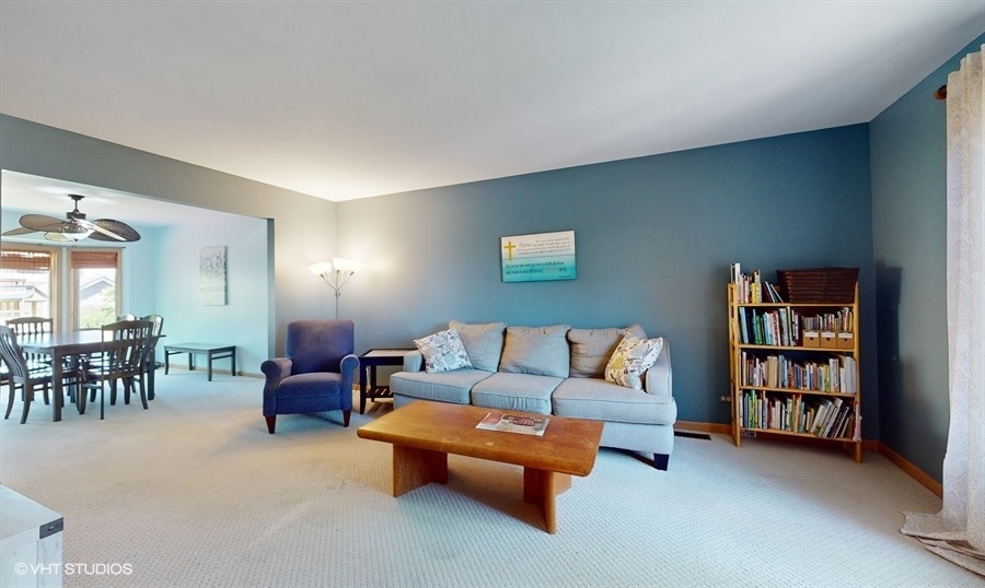 545 Abbey Road Bartlett, IL 60103 - Photo 2 of 28 a living room with furniture a bookshelf and a window