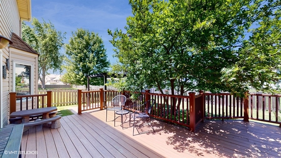 545 Abbey Road Bartlett, IL 60103 - Photo 23 of 28 a view of a wooden deck with a bench