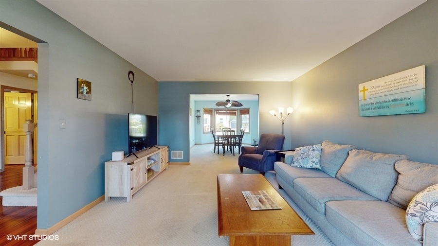 545 Abbey Road Bartlett, IL 60103 - Photo 3 of 28 a living room with furniture and a flat screen tv
