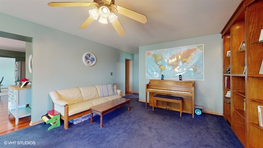 545 Abbey Road Bartlett, IL 60103 - Photo 4 of 28 a living room with furniture and a baby crib