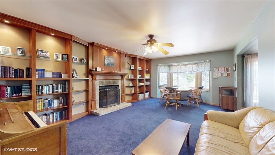 545 Abbey Road Bartlett, IL 60103 - Photo 5 of 28 a living room with furniture and a book shelf