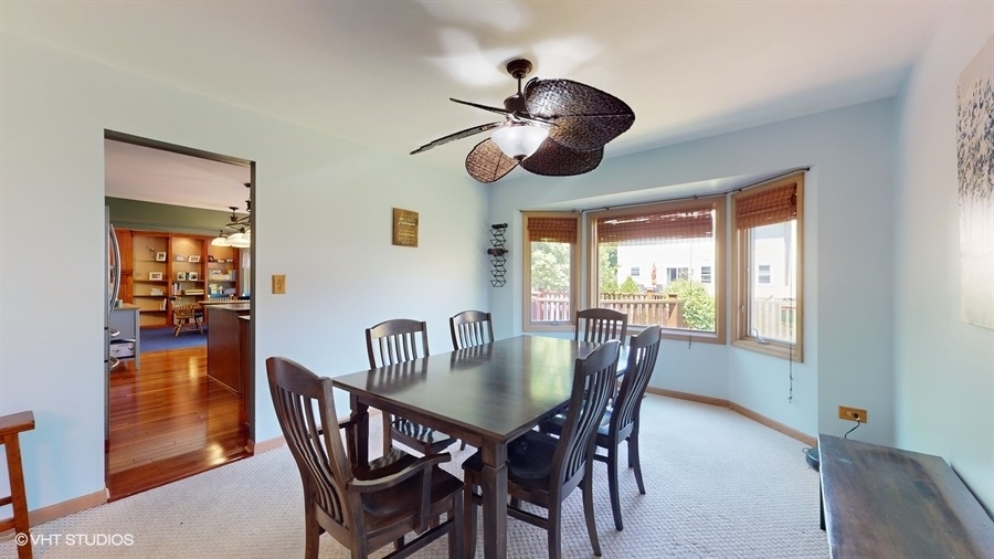 545 Abbey Road Bartlett, IL 60103 - Photo 7 of 28 a dining room with furniture a chandelier and window