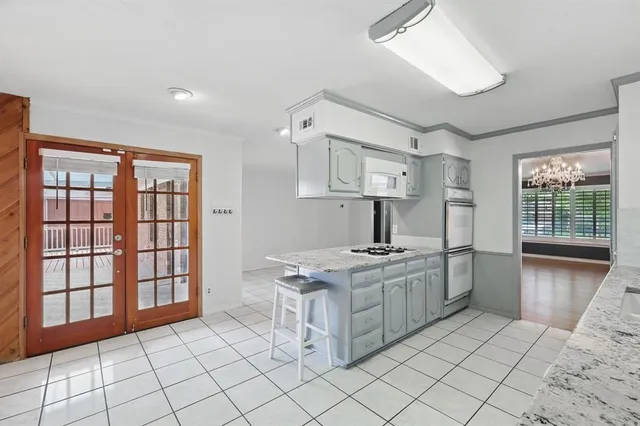 a kitchen with a stove a table and chairs