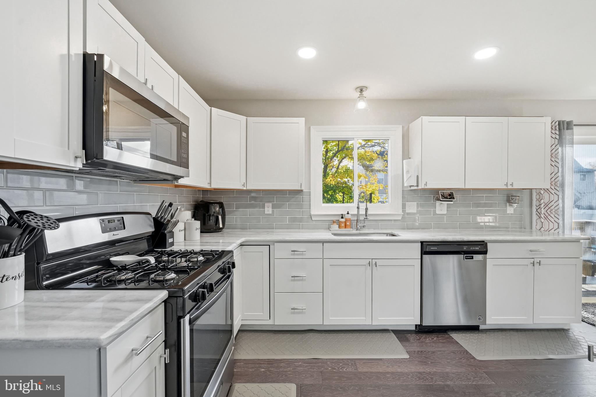 16 Sumner Avenue Berlin, NJ 08009 - Photo 12 of 30 a kitchen with stainless steel appliances granite countertop a stove a sink and a microwave
