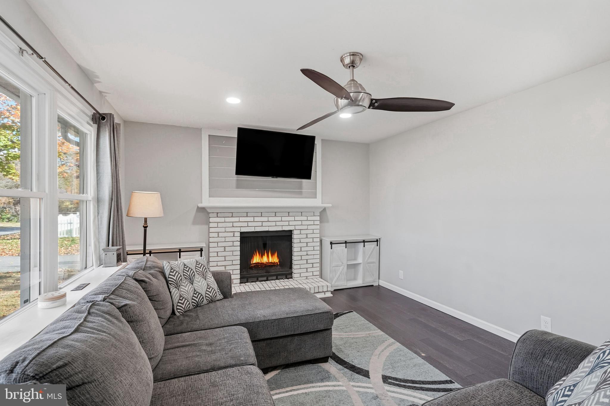 16 Sumner Avenue Berlin, NJ 08009 - Photo 4 of 30 a living room with furniture a fireplace and a flat screen tv