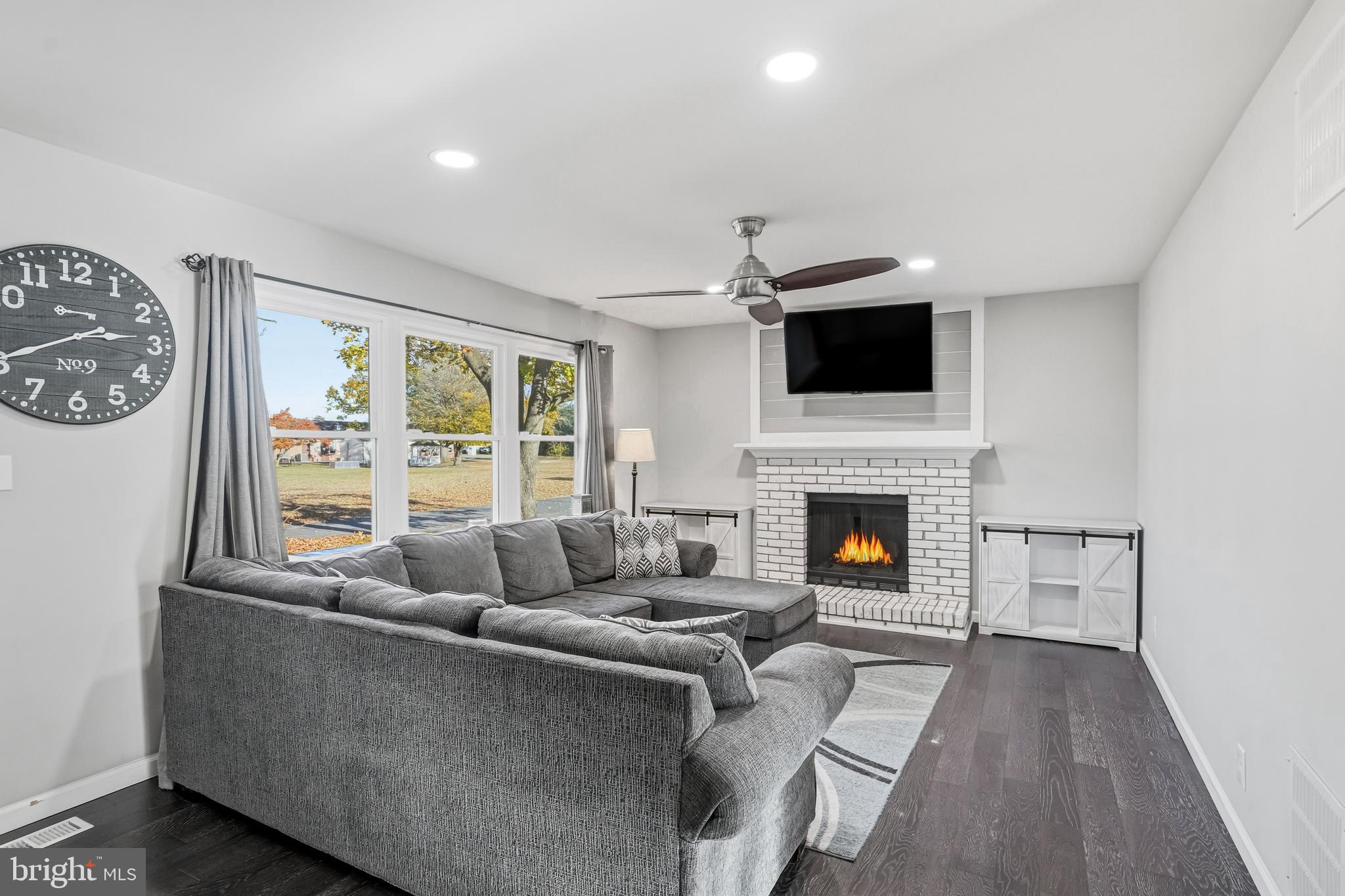 16 Sumner Avenue Berlin, NJ 08009 - Photo 5 of 30 a living room with furniture a flat screen tv and a fireplace