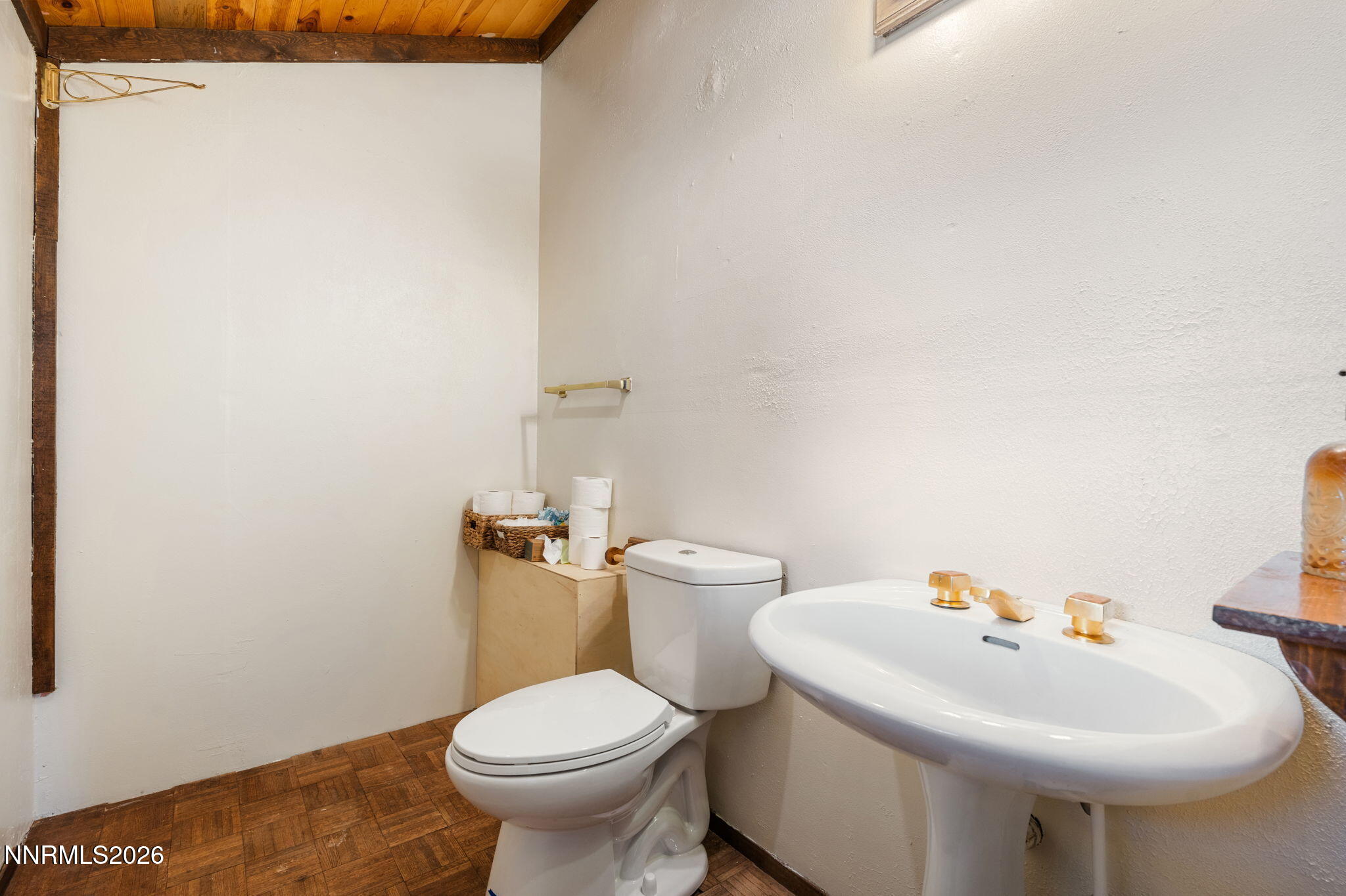 21845 Adobe Road Reno, NV 89521 - Photo 26 of 65 a white toilet sitting next to a bathroom sink