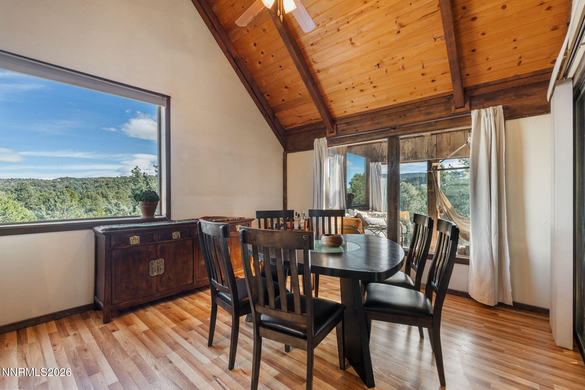 21845 Adobe Road Reno, NV 89521 - Photo 33 of 65 a view of a dining room with furniture window and wooden floor
