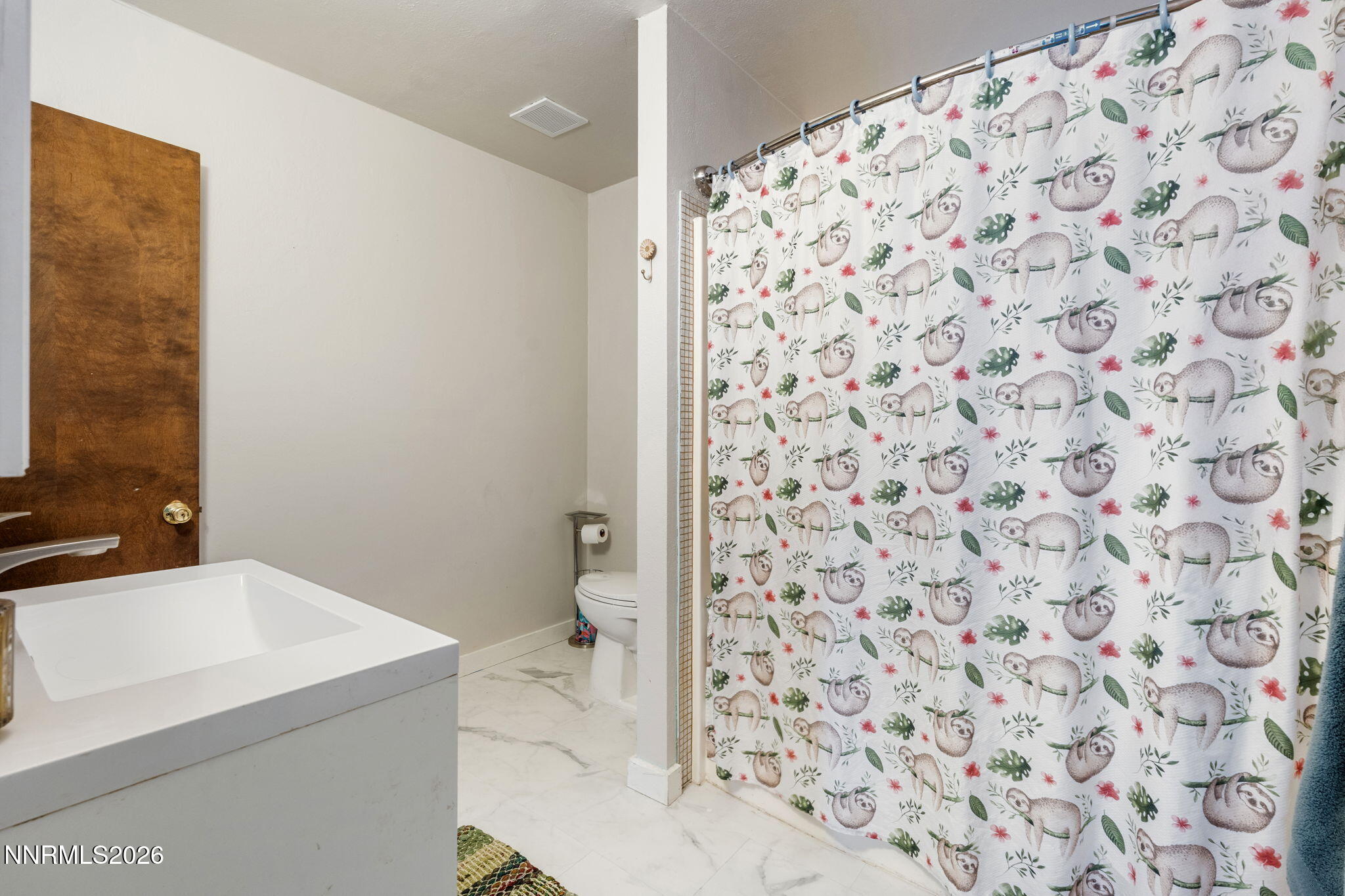 21845 Adobe Road Reno, NV 89521 - Photo 49 of 65 a bathroom with a sink and a toilet