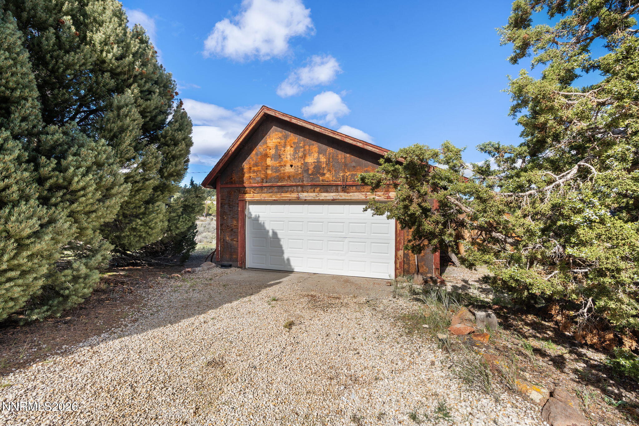 21845 Adobe Road Reno, NV 89521 - Photo 5 of 65 a front view of a house with a yard and garage