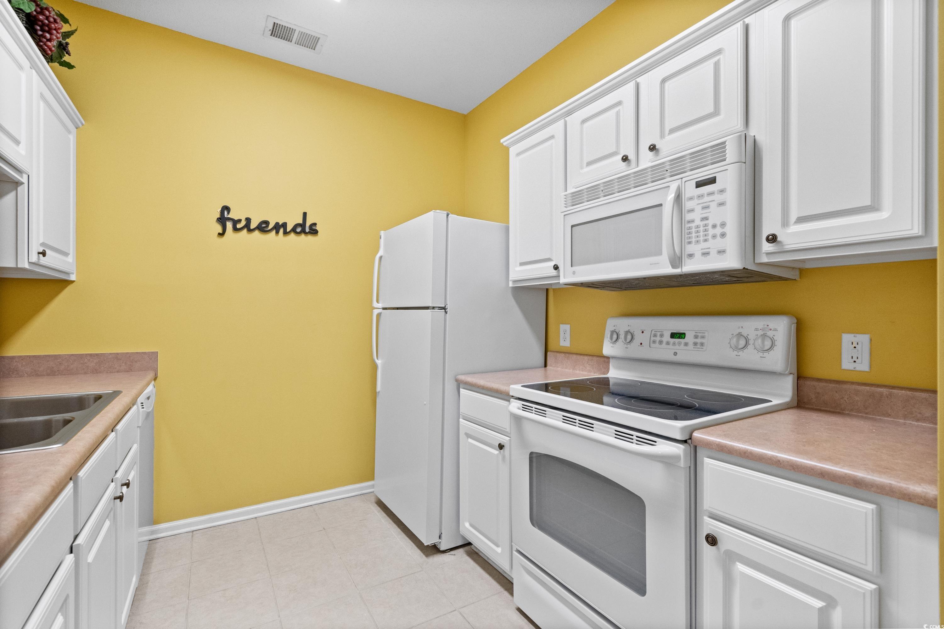 2050 Cross Gate Boulevard, Unit 303 Myrtle Beach, SC 29575 - Photo 13 of 35 Kitchen featuring sink, white appliances, and white cabinets