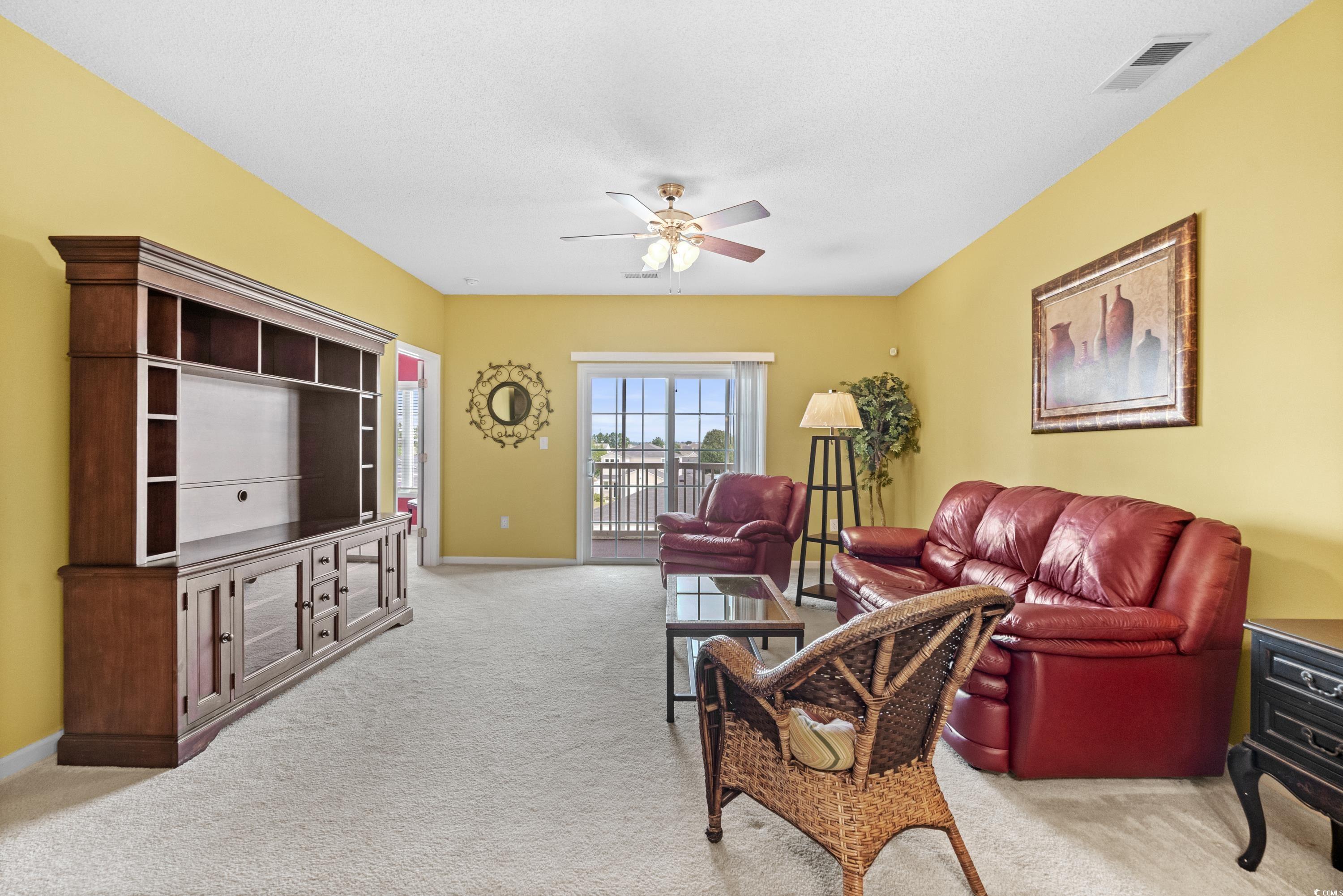 2050 Cross Gate Boulevard, Unit 303 Myrtle Beach, SC 29575 - Photo 15 of 35 Living room with ceiling fan and carpet floors
