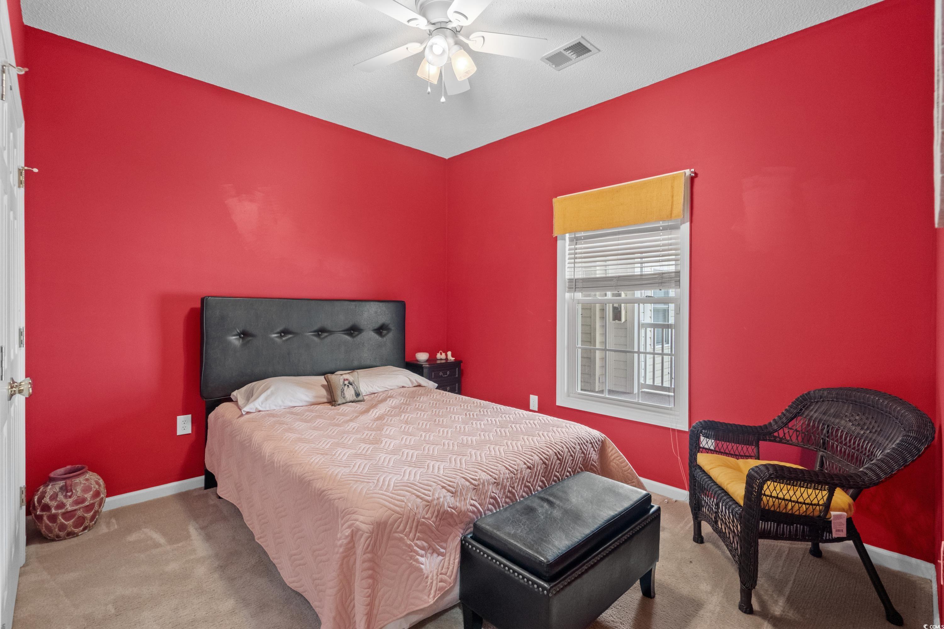 2050 Cross Gate Boulevard, Unit 303 Myrtle Beach, SC 29575 - Photo 25 of 35 Bedroom featuring ceiling fan and carpet floors